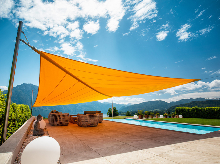 Oranges Sonnensegel auf einer Terrasse mit Pool